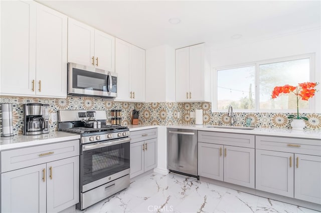 kitchen featuring light tile patterned flooring, sink, tasteful backsplash, and stainless steel appliances