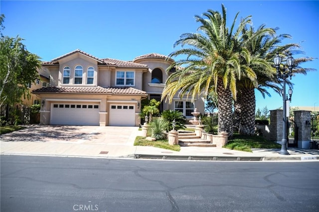 mediterranean / spanish home featuring a garage