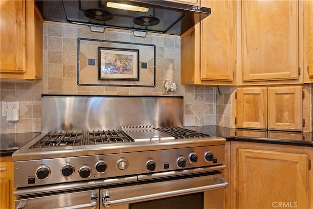 kitchen with dark countertops, tasteful backsplash, stainless steel range, and ventilation hood