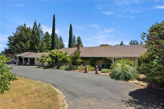 single story home featuring driveway