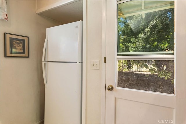 kitchen featuring freestanding refrigerator