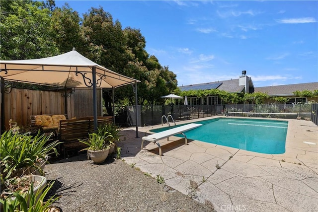 view of pool featuring a fenced in pool, a patio, a gazebo, fence, and a diving board