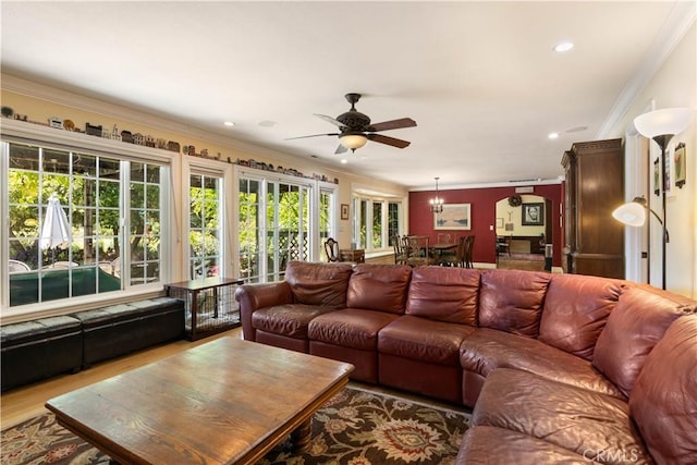 living area featuring recessed lighting, ceiling fan, crown molding, and wood finished floors