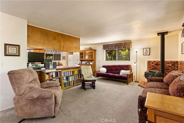 living area featuring carpet flooring and a wood stove