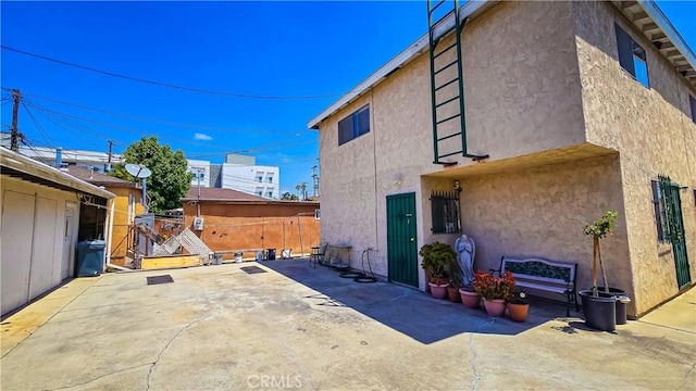 view of property exterior with a patio area