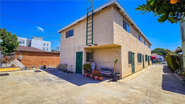 947 S Sunol Dr, Los Angeles, CA 90023 - back of property featuring stucco siding and a patio area