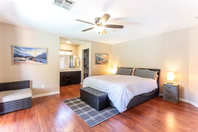 bedroom with dark hardwood / wood-style floors, ceiling fan, and ensuite bathroom