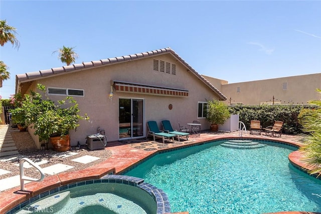 view of pool with an in ground hot tub and a patio