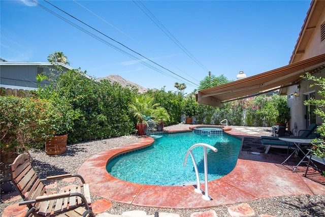 view of swimming pool featuring an in ground hot tub and a patio