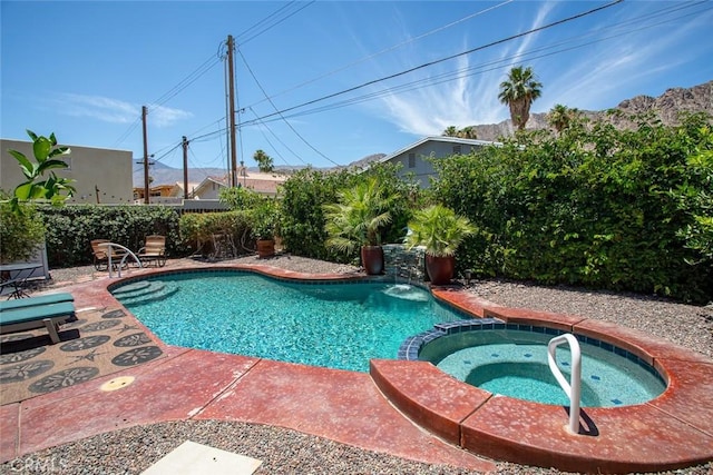 view of swimming pool featuring an in ground hot tub and a patio