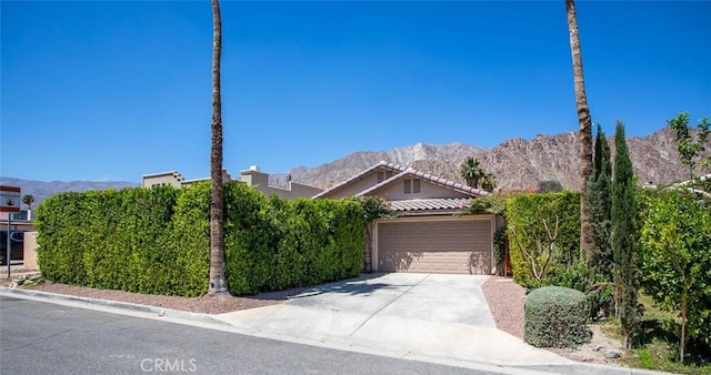 view of front of house featuring a mountain view and a garage