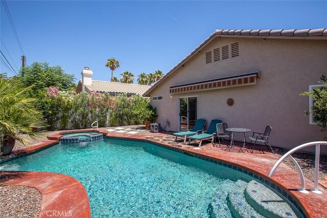 view of swimming pool with an in ground hot tub and a patio