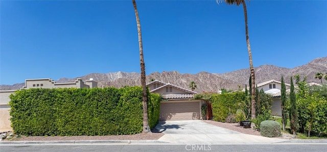 obstructed view of property featuring a mountain view and a garage