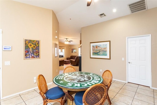 tiled dining room with vaulted ceiling and ceiling fan