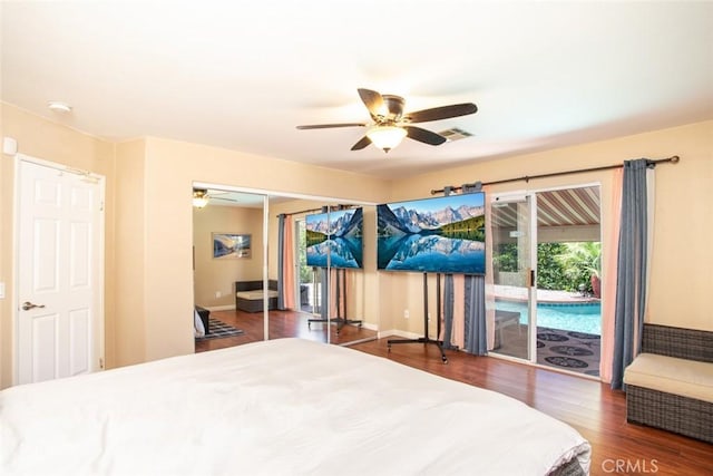 bedroom with ceiling fan, dark hardwood / wood-style floors, access to outside, and a closet