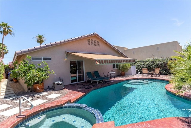 view of swimming pool with an in ground hot tub and a patio area