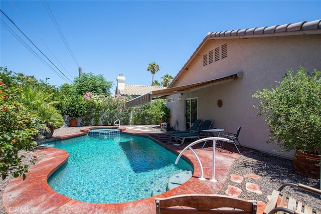 view of swimming pool with an in ground hot tub and a patio