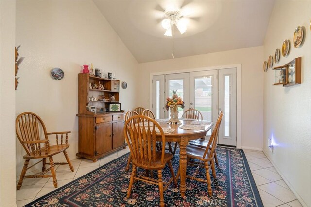 dining area with french doors, high vaulted ceiling, ceiling fan, and light tile patterned flooring