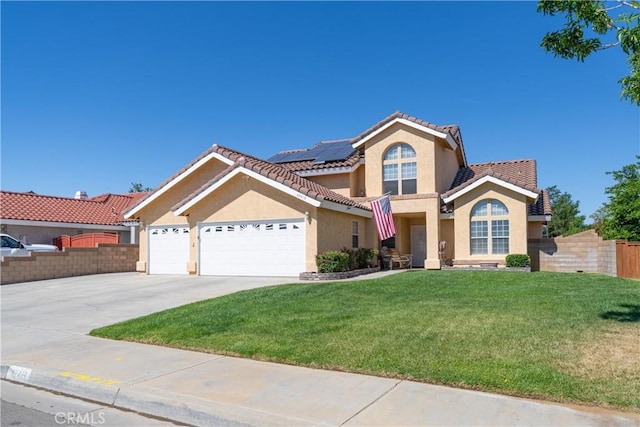 view of front of property with solar panels, a garage, and a front lawn