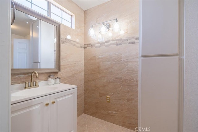 bathroom with vanity, tile walls, and tasteful backsplash