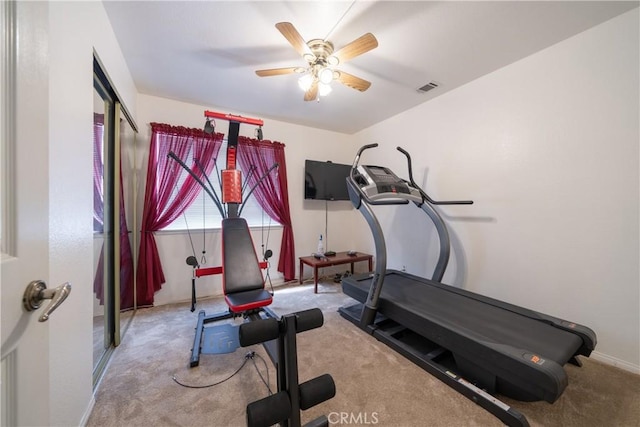 workout room with ceiling fan and light carpet