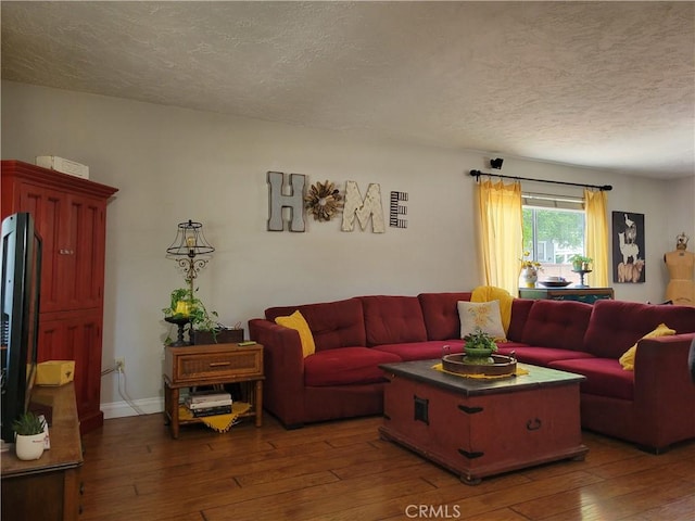 living room featuring dark hardwood / wood-style floors and a textured ceiling