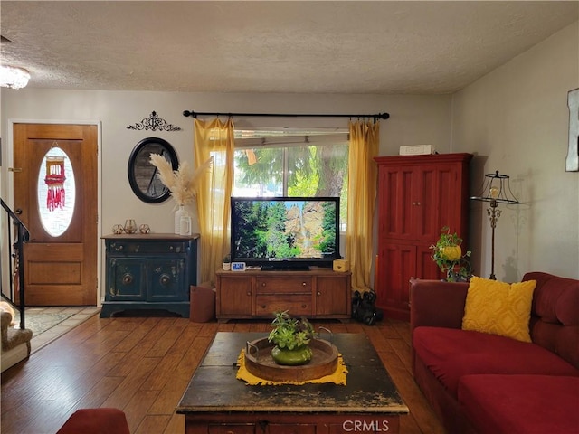 living room featuring hardwood / wood-style floors and a textured ceiling