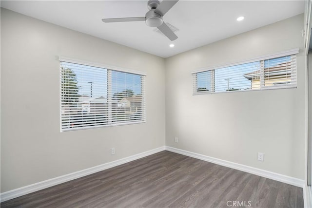 spare room with ceiling fan, dark hardwood / wood-style flooring, and a healthy amount of sunlight