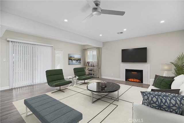 living room with light wood-type flooring and ceiling fan