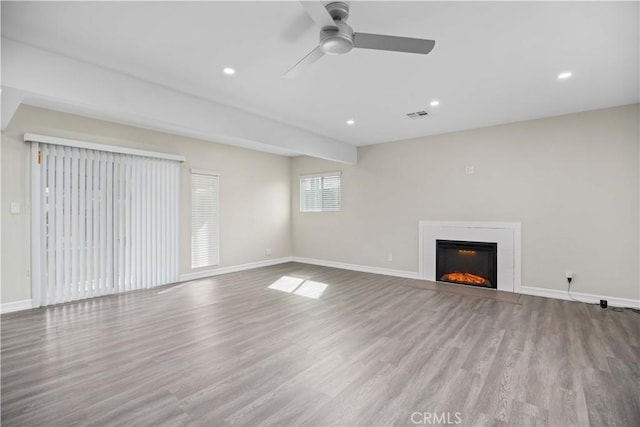 unfurnished living room featuring ceiling fan and light wood-type flooring