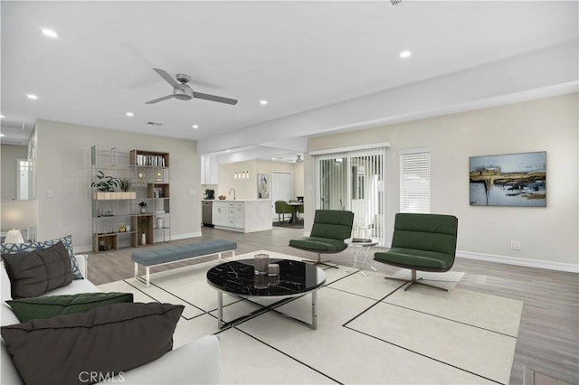 living room featuring hardwood / wood-style floors and ceiling fan