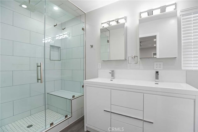 bathroom with vanity and a shower with shower door