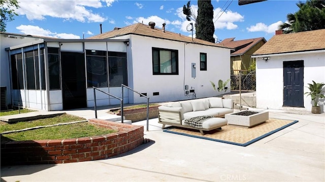 back of property with an outdoor hangout area, a patio, and a sunroom