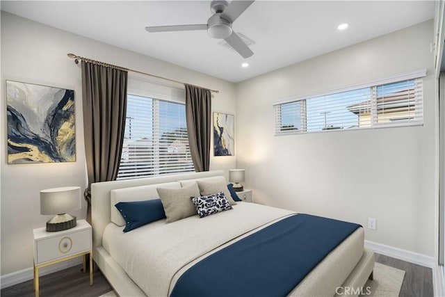 bedroom with multiple windows, hardwood / wood-style flooring, and ceiling fan