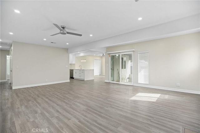 unfurnished living room with light hardwood / wood-style floors and ceiling fan