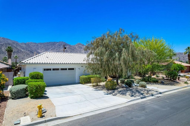 view of front of house with a mountain view and a garage