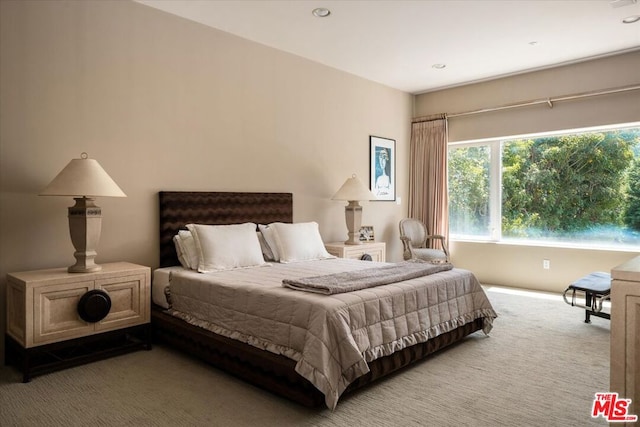 bedroom featuring light carpet