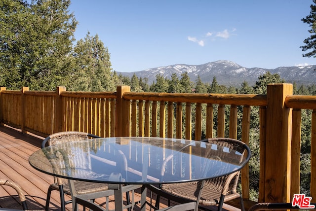 wooden deck with a mountain view