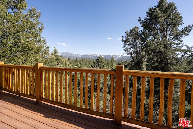 wooden deck with a mountain view