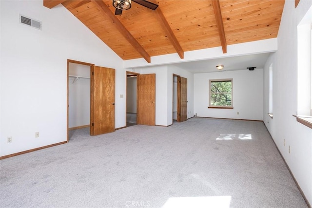 unfurnished bedroom featuring visible vents, wooden ceiling, beamed ceiling, carpet flooring, and high vaulted ceiling