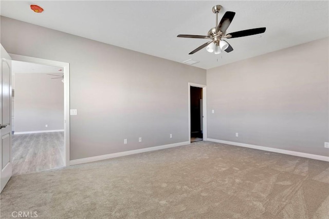 unfurnished room with ceiling fan and light carpet