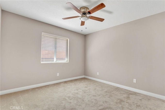 unfurnished room with ceiling fan and light colored carpet