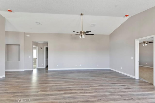 spare room with ceiling fan, hardwood / wood-style floors, and high vaulted ceiling