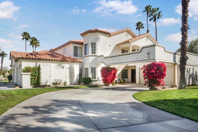 mediterranean / spanish-style house with a garage and a front yard