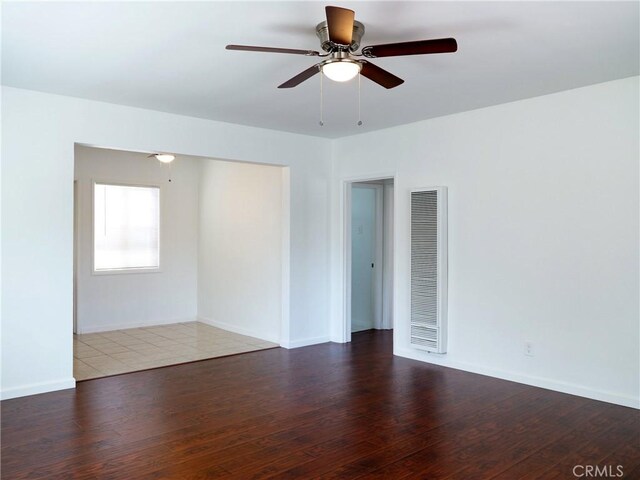 empty room featuring ceiling fan and dark hardwood / wood-style floors