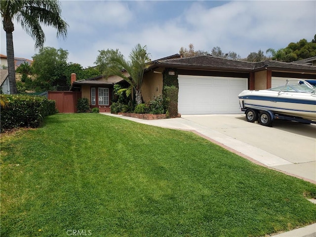 view of front of home featuring a front yard and a garage