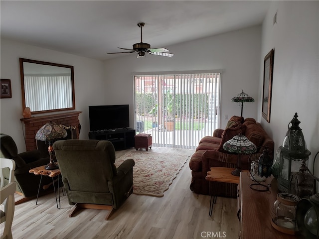 living room featuring ceiling fan and light wood-type flooring