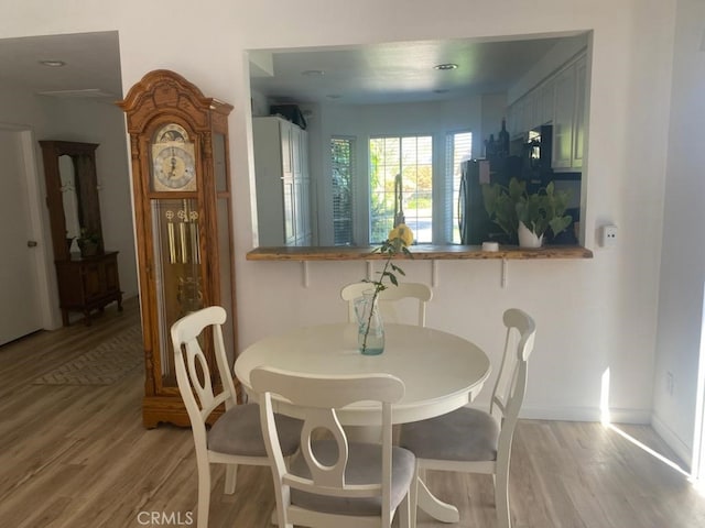 dining space with light hardwood / wood-style floors