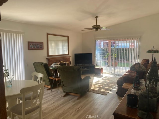 living room with wood-type flooring and ceiling fan