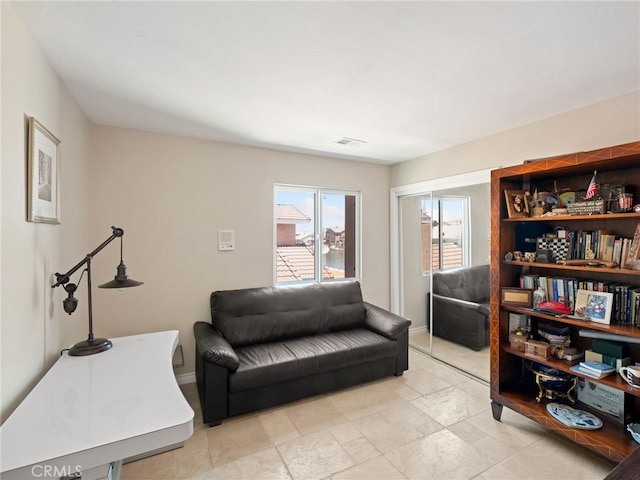 living area featuring visible vents and baseboards